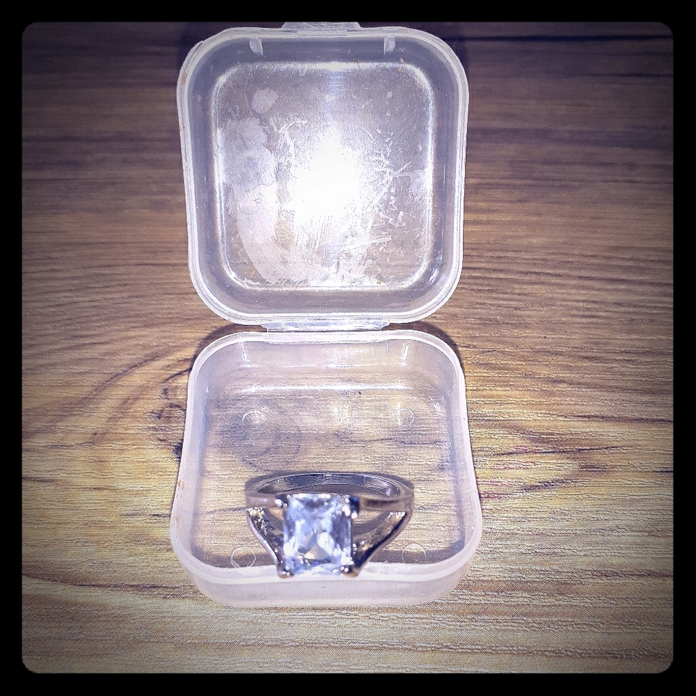 Square cut white sapphire ring.